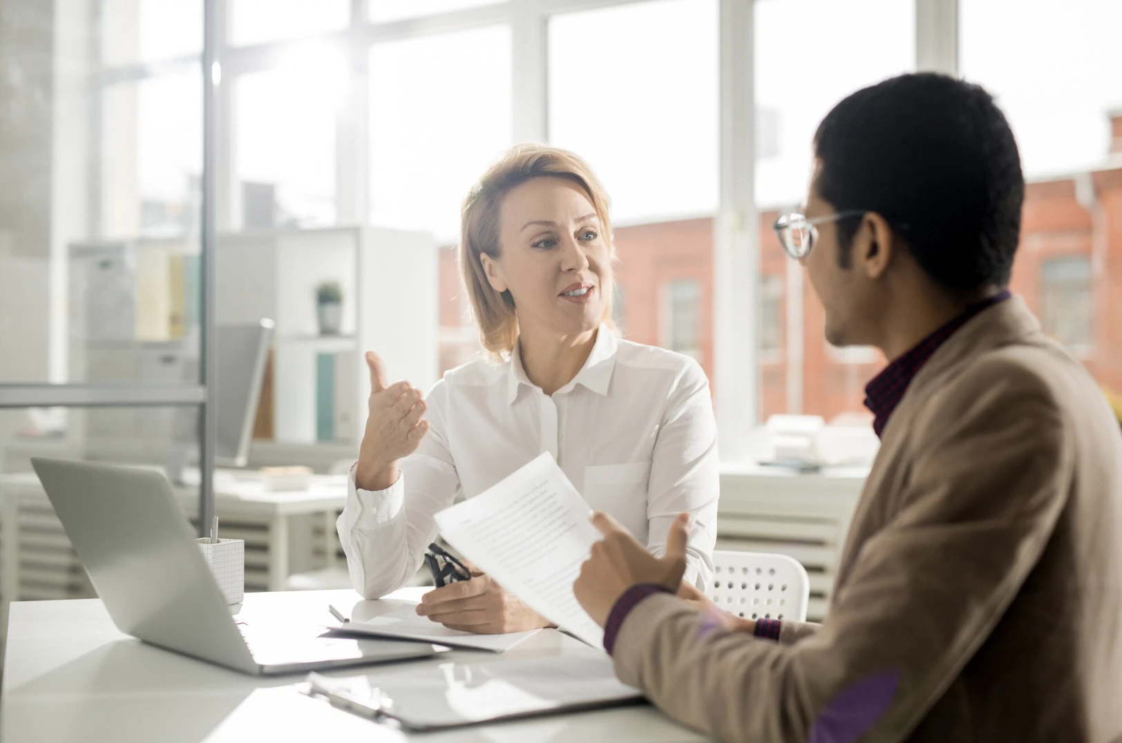 A financing advisor talking through options with a customer across a desk